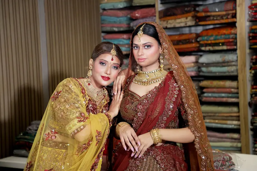 The shop floor with sarees stacked on open shelves.