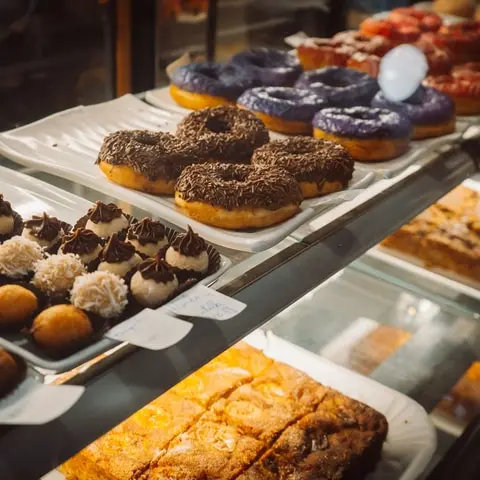 A bakery display case, a plate of choux pastries and a plated dessert (1)