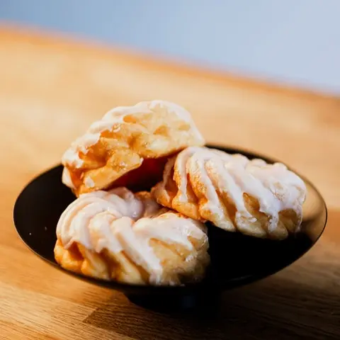 A bakery display case, a plate of choux pastries and a plated dessert (2)